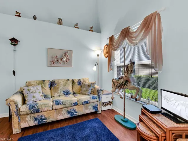 Living area with wood finished floors and baseboards