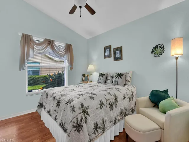 Bedroom featuring lofted ceiling, wood finished floors, and ceiling fan