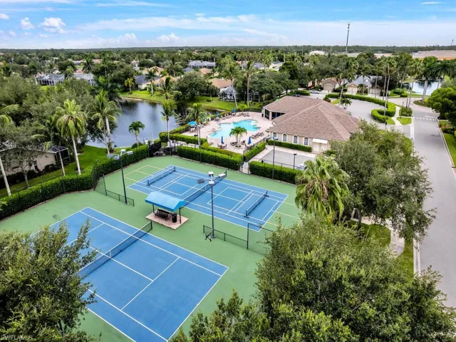 Aerial view of residential area featuring a pool area and a large body of water
