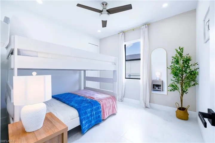 Bedroom with a ceiling fan and baseboards