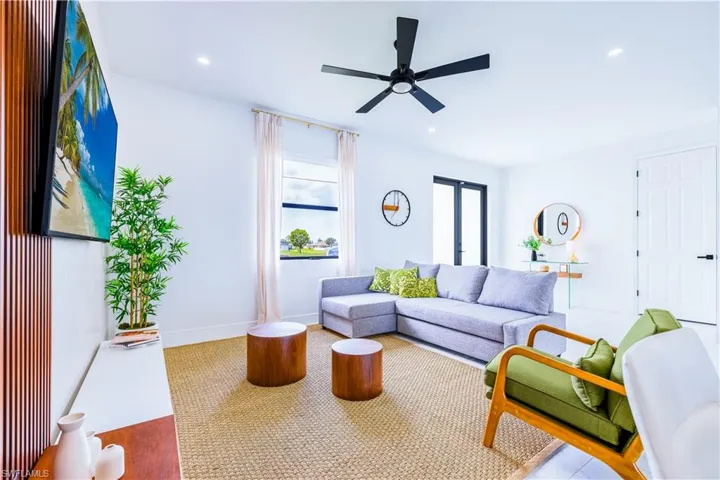 Living area featuring wood finished floors, recessed lighting, and ceiling fan