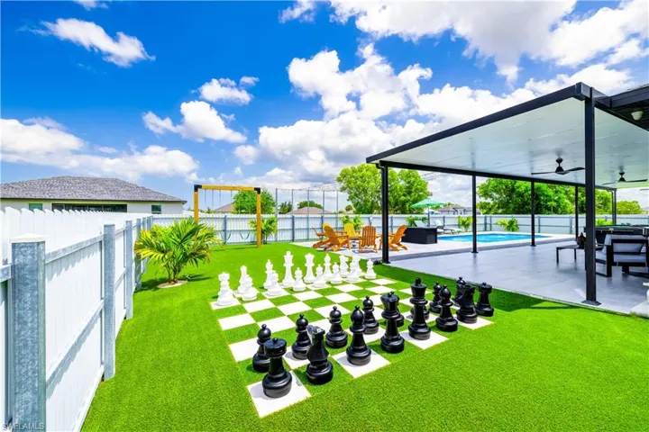 Fenced backyard featuring ceiling fan and a patio area