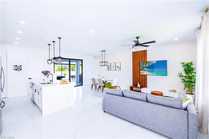 Living room with light marble finish floors and recessed lighting
