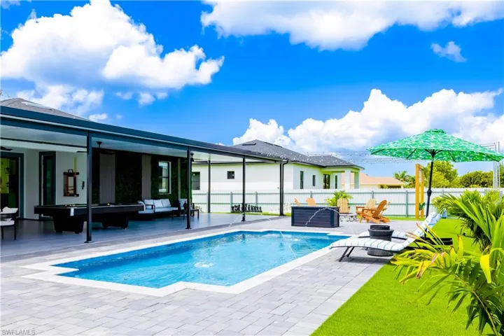 Back of property with an outdoor living space, a patio, a fenced backyard, and ceiling fan