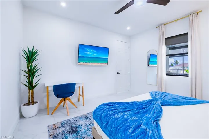 Bedroom with a ceiling fan and recessed lighting