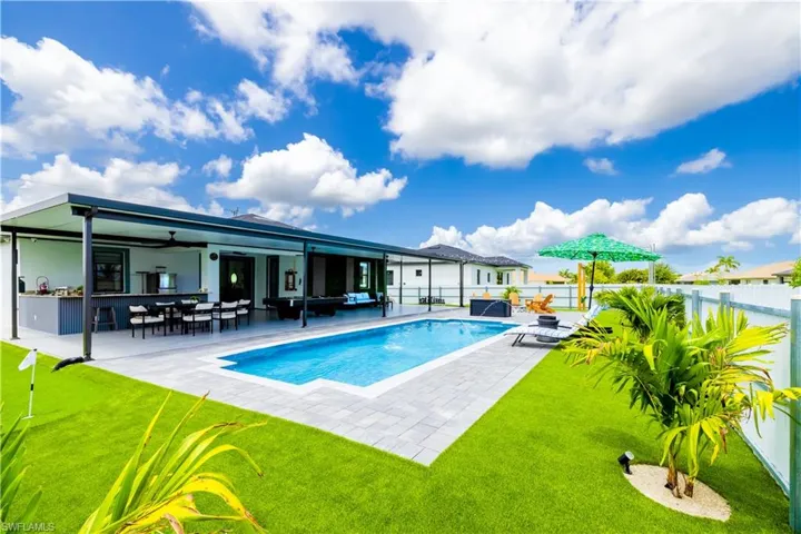 Back of house featuring a fenced backyard, ceiling fan, a patio area, and an outdoor living space