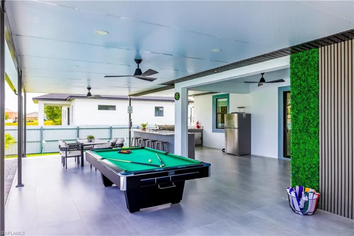 Recreation room featuring a ceiling fan, billiards, recessed lighting, and floor to ceiling windows