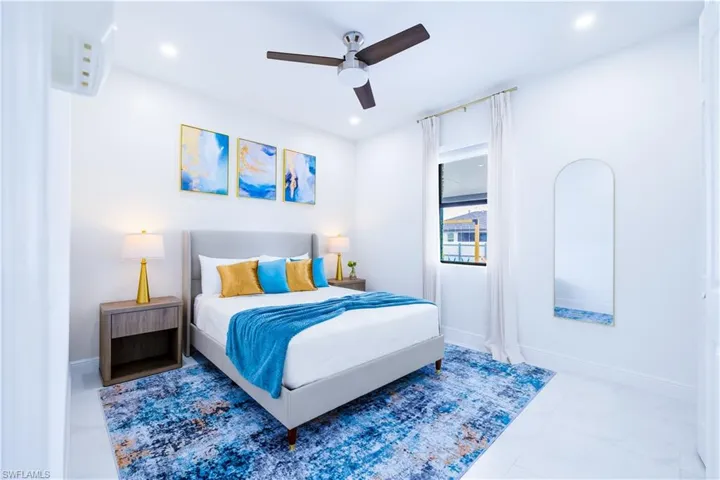 Bedroom featuring ceiling fan, marble finish flooring, and recessed lighting