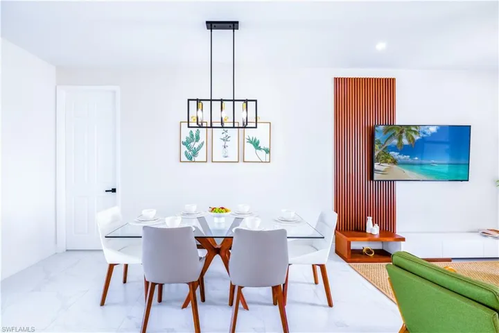 Dining room featuring a chandelier and marble finish floors