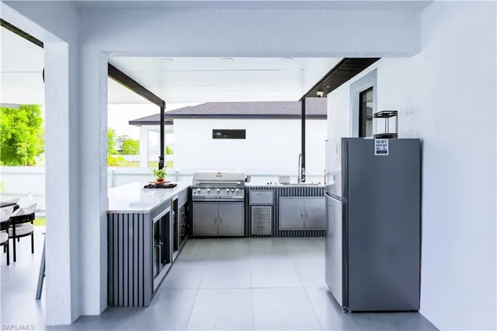 View of patio featuring area for grilling and a sink