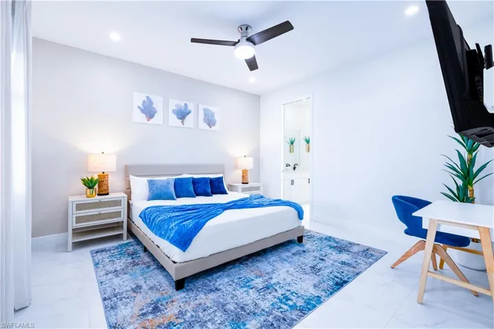 Bedroom featuring marble finish flooring, a ceiling fan, connected bathroom, and recessed lighting