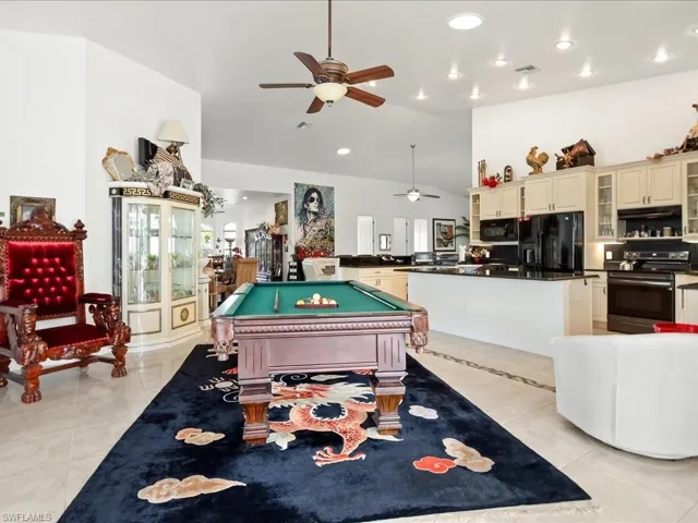 Game room with lofted ceiling, ceiling fan, billiards table, light tile patterned floors, and recessed lighting