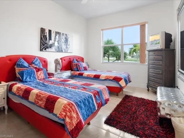 Bedroom with a ceiling fan and light tile patterned floors