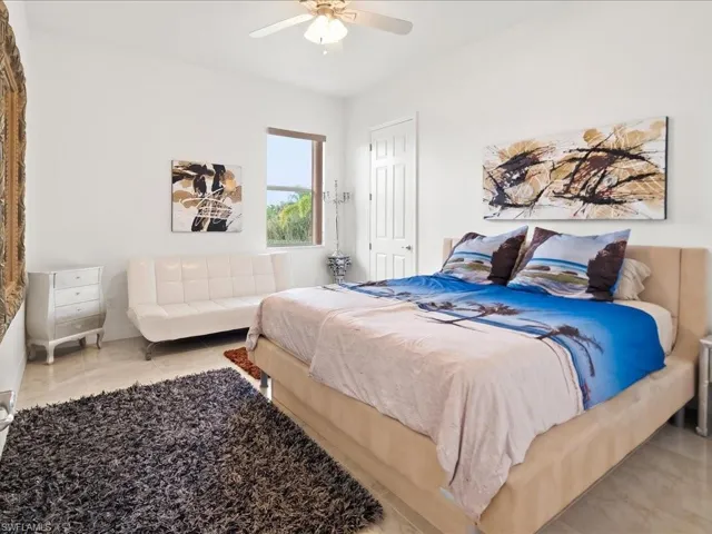Bedroom with ceiling fan and light tile patterned floors