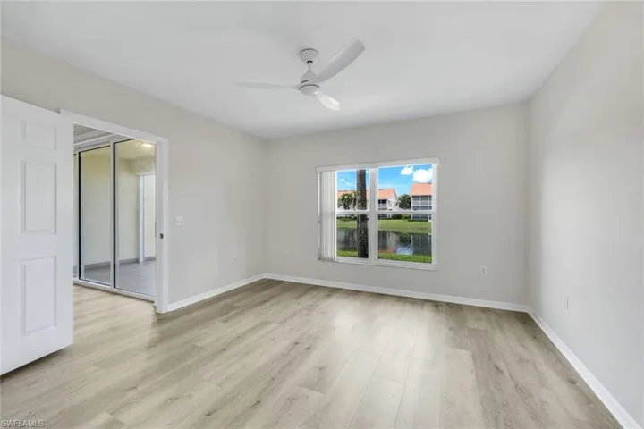 Empty room featuring light wood-type flooring and ceiling fan