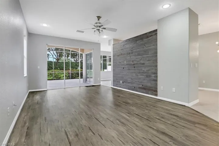 Empty room featuring ceiling fan and hardwood / wood-style flooring