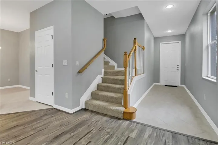 Entrance foyer with light wood-type flooring