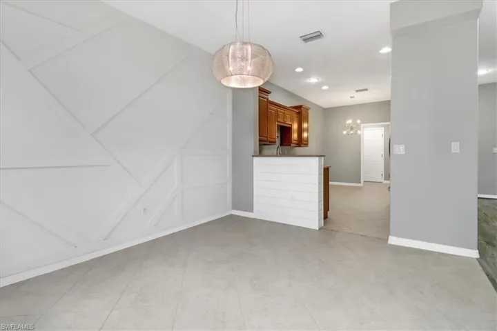 Unfurnished dining area featuring light tile patterned floors
