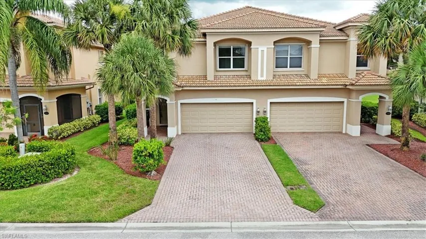 Mediterranean / spanish-style home with a garage