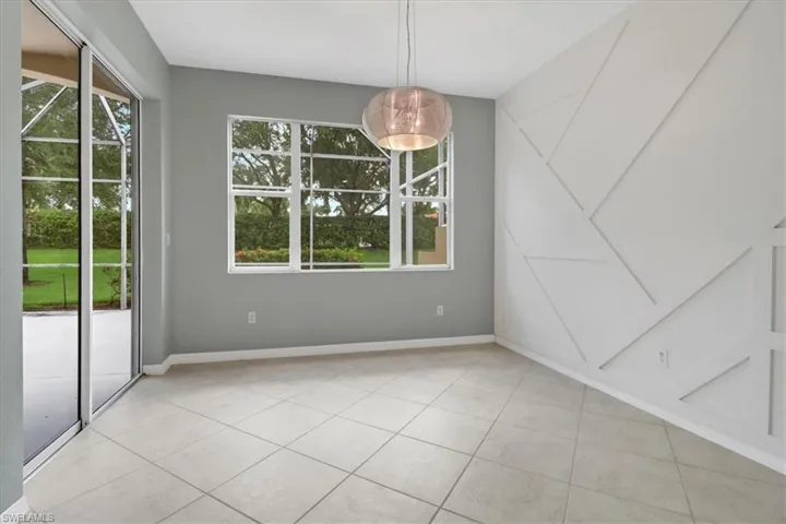 Unfurnished dining area featuring plenty of natural light and light tile patterned floors