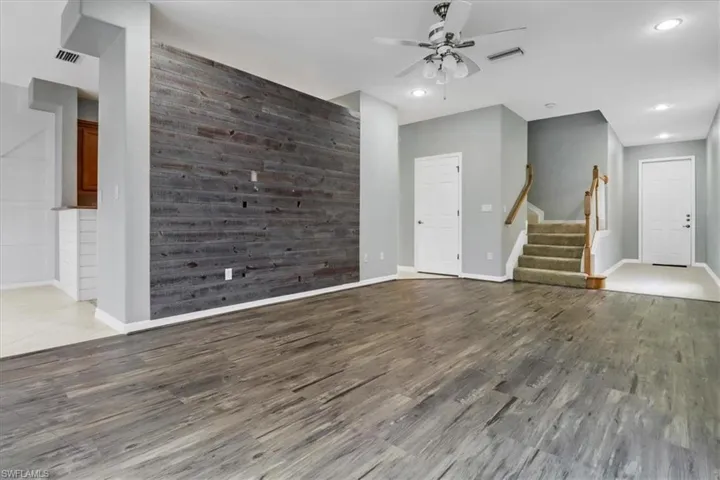 Empty room featuring ceiling fan and hardwood / wood-style floors