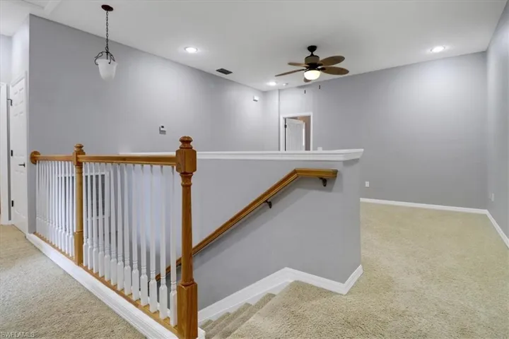 Stairs with carpet and ceiling fan