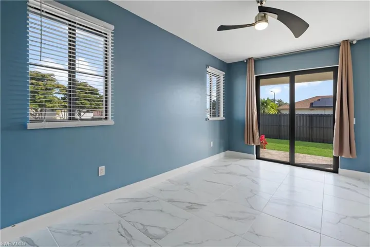 Interior room featuring white marble-look tile flooring and blue wall finishes