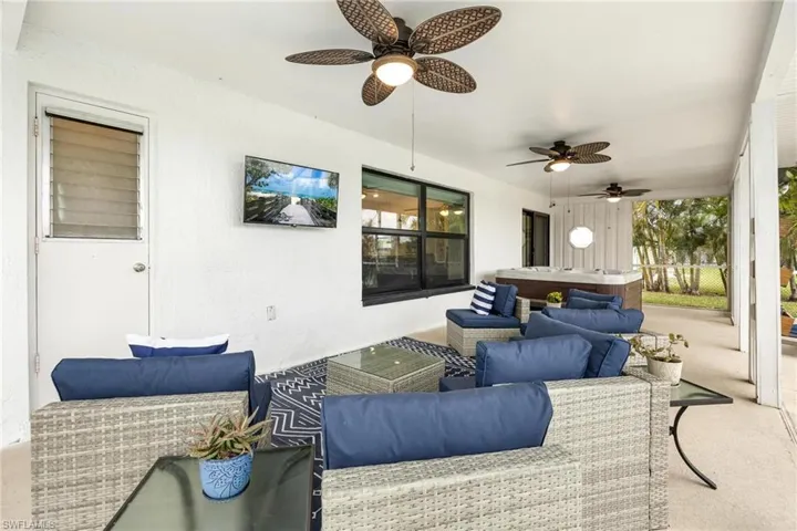 View of patio with ceiling fan and an outdoor living space