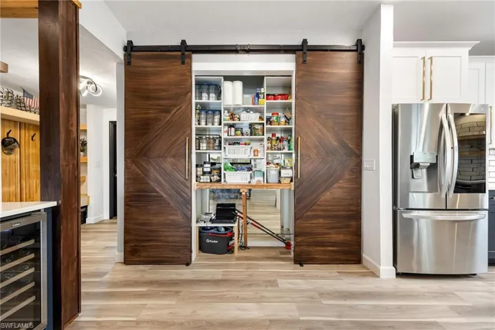 Pantry with barn door and hidden storage