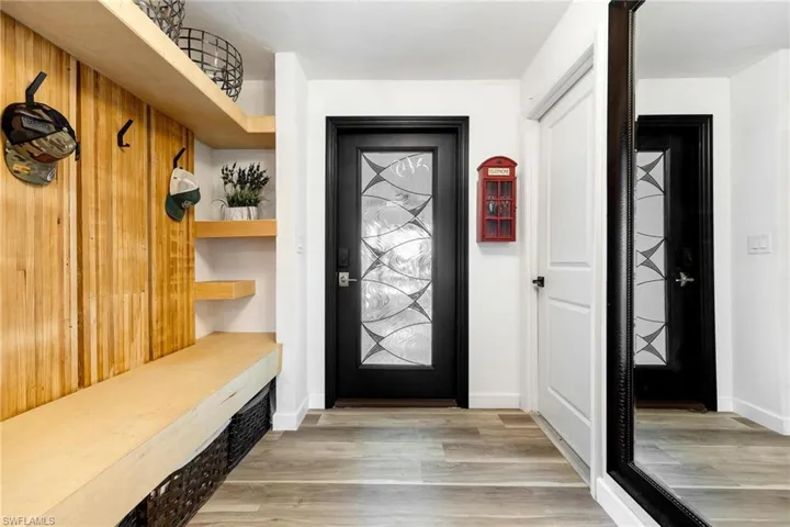 Front door entry with built in bench and nooks for storage