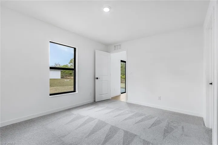 Carpeted empty room with plenty of natural light