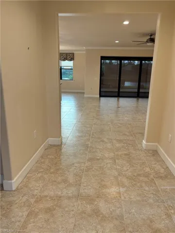 wide open entry way featuring custom molding and light tile patterned floors