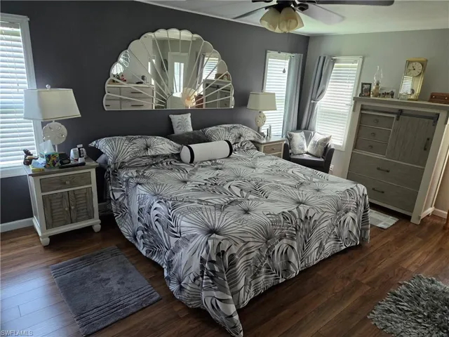 Bedroom featuring dark wood-type flooring and ceiling fan