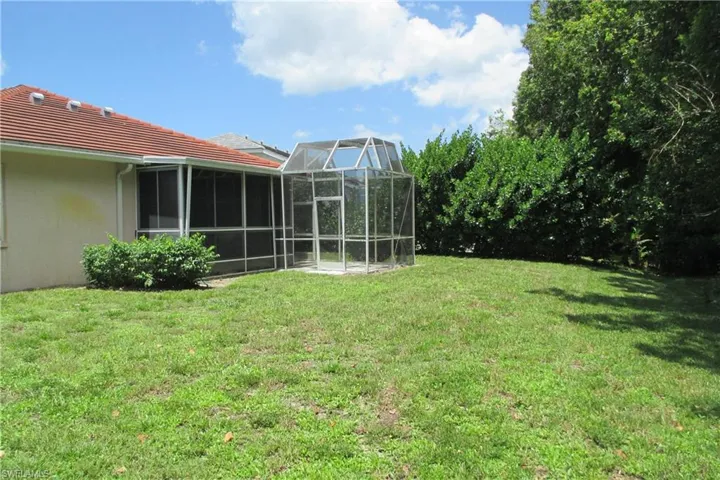 View of yard featuring glass enclosure