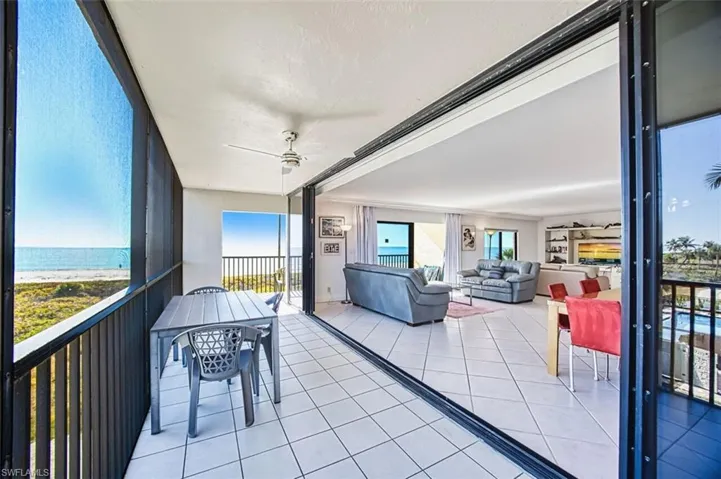 Living and dining area exits to lanai with direct gulf views
