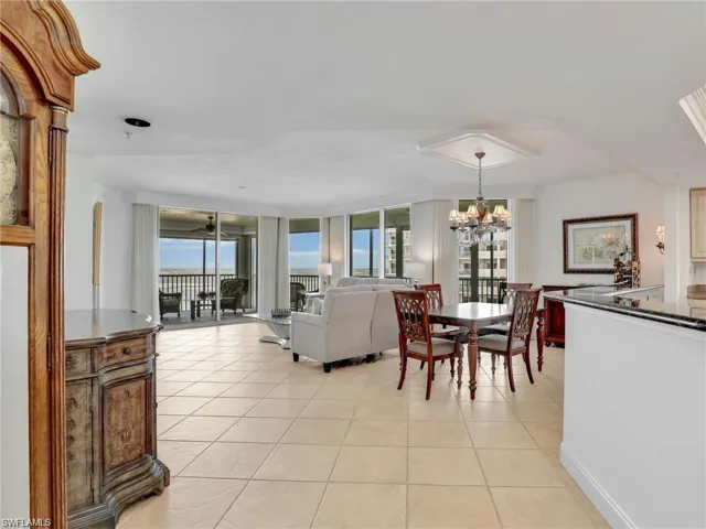 Dining room featuring floor to ceiling windows, light tile patterned flooring, and a chandelier