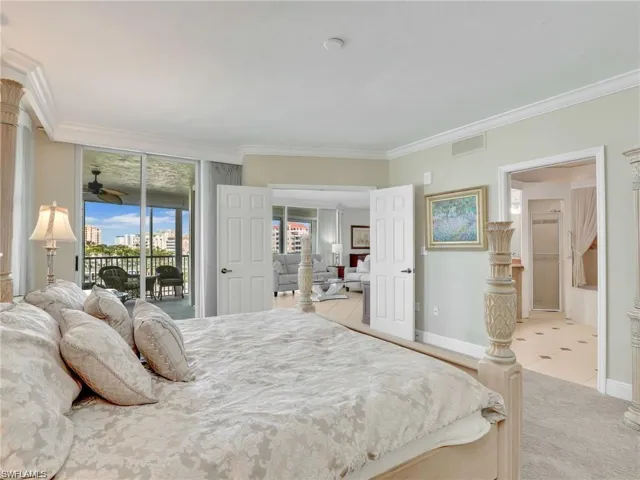 Bedroom featuring access to exterior, crown molding, light colored carpet, and light tile patterned flooring