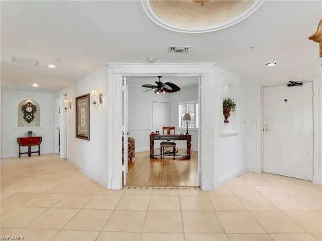 Corridor with recessed lighting and light tile patterned floors