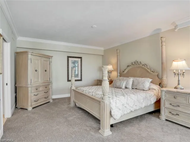 Bedroom featuring ornamental molding and light colored carpet