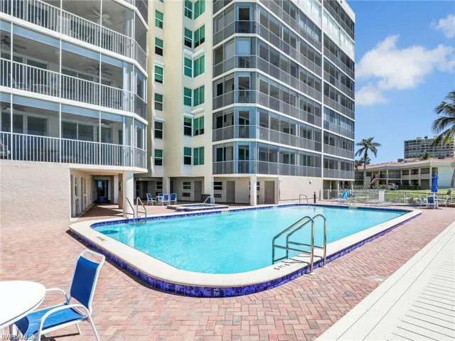 Community pool featuring a patio