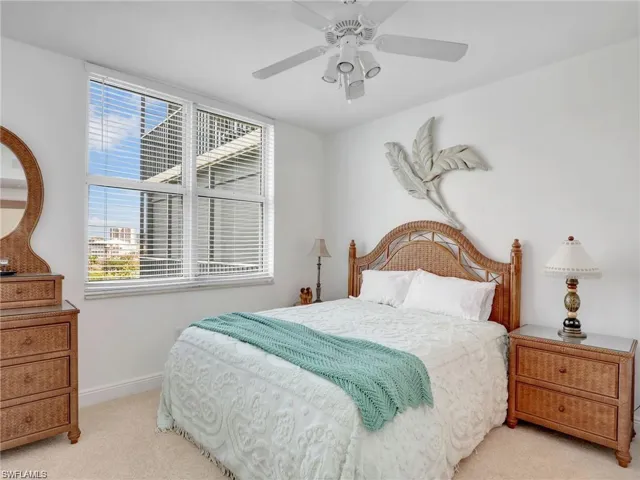 Bedroom featuring light carpet and ceiling fan