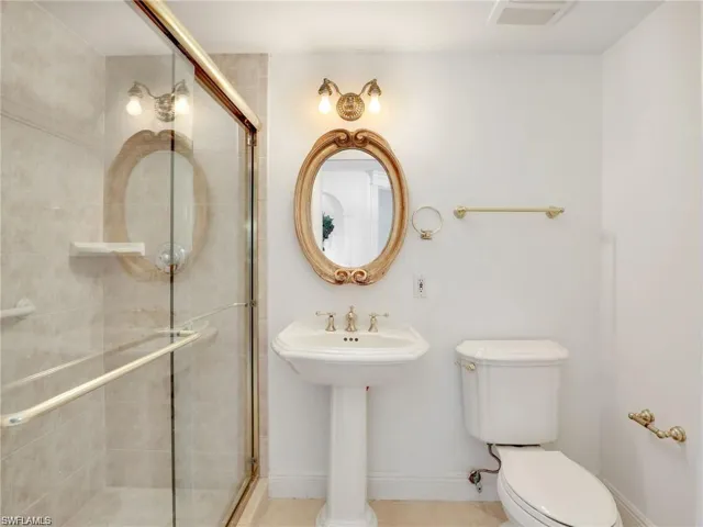 Full bath with a shower stall and tile patterned flooring