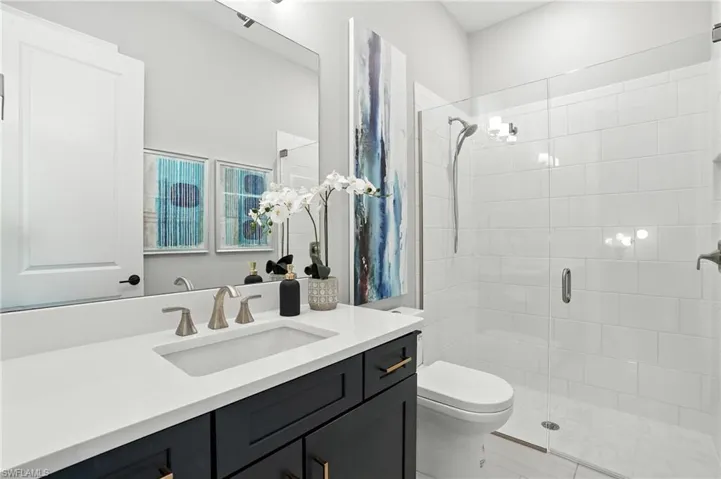 Full bathroom with a shower stall and vanity