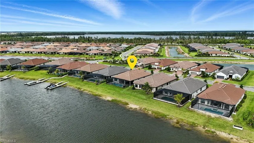 Aerial perspective of suburban area featuring a nearby body of water