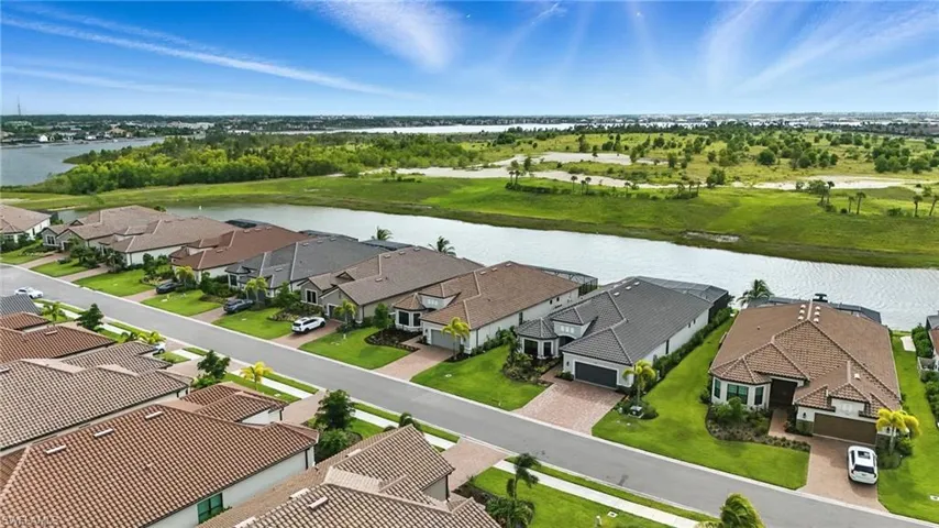 Aerial perspective of suburban area with a nearby body of water
