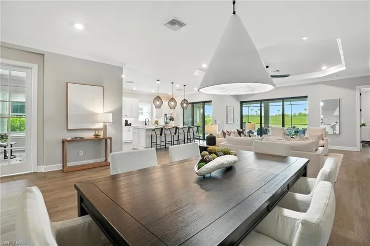 Dining room featuring ornamental molding, recessed lighting, healthy amount of natural light, and light wood finished floors