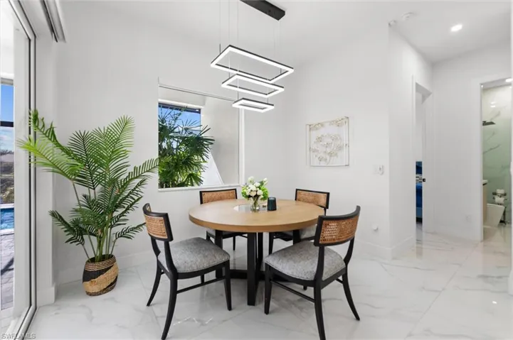 Dining space with baseboards and recessed lighting