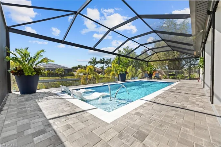 Swimming pool with a patio, a lanai, and a sunroom