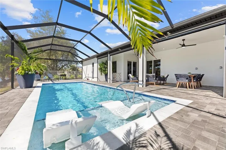 Outdoor pool featuring outdoor dining area, a lanai, a patio area, and a sunroom