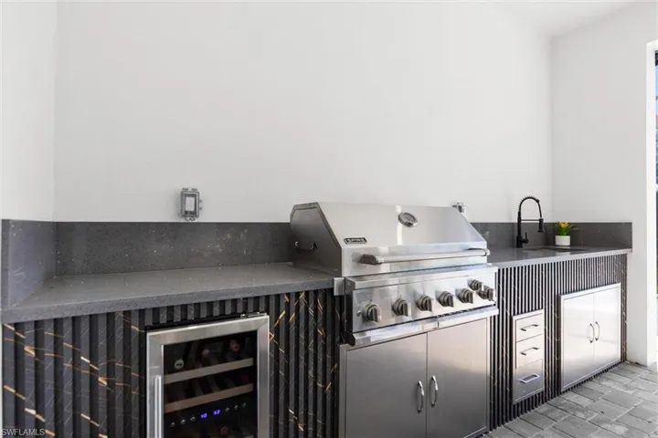 View of patio featuring beverage cooler and exterior kitchen